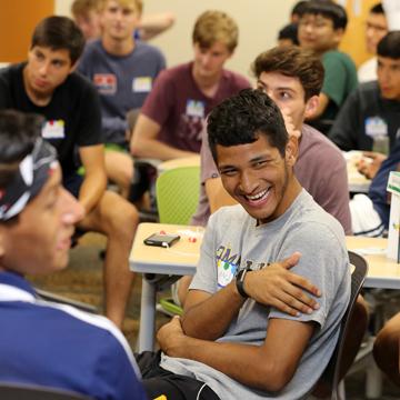 A student in a class laughs during a class discussion.